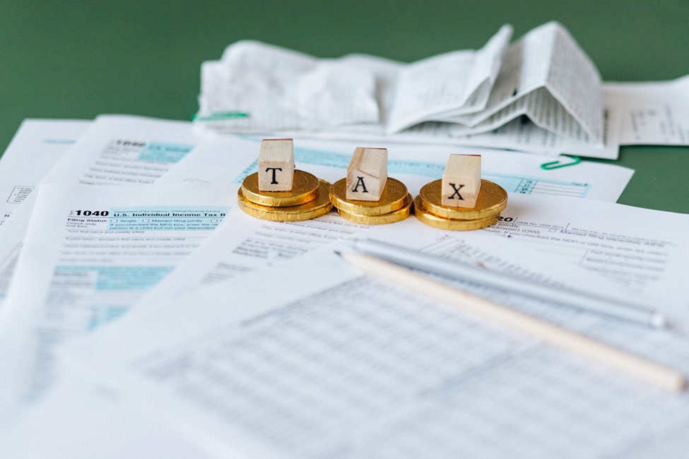 Tax documents and some coins on the table