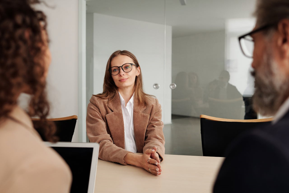  Woman seated at a table during a job interview